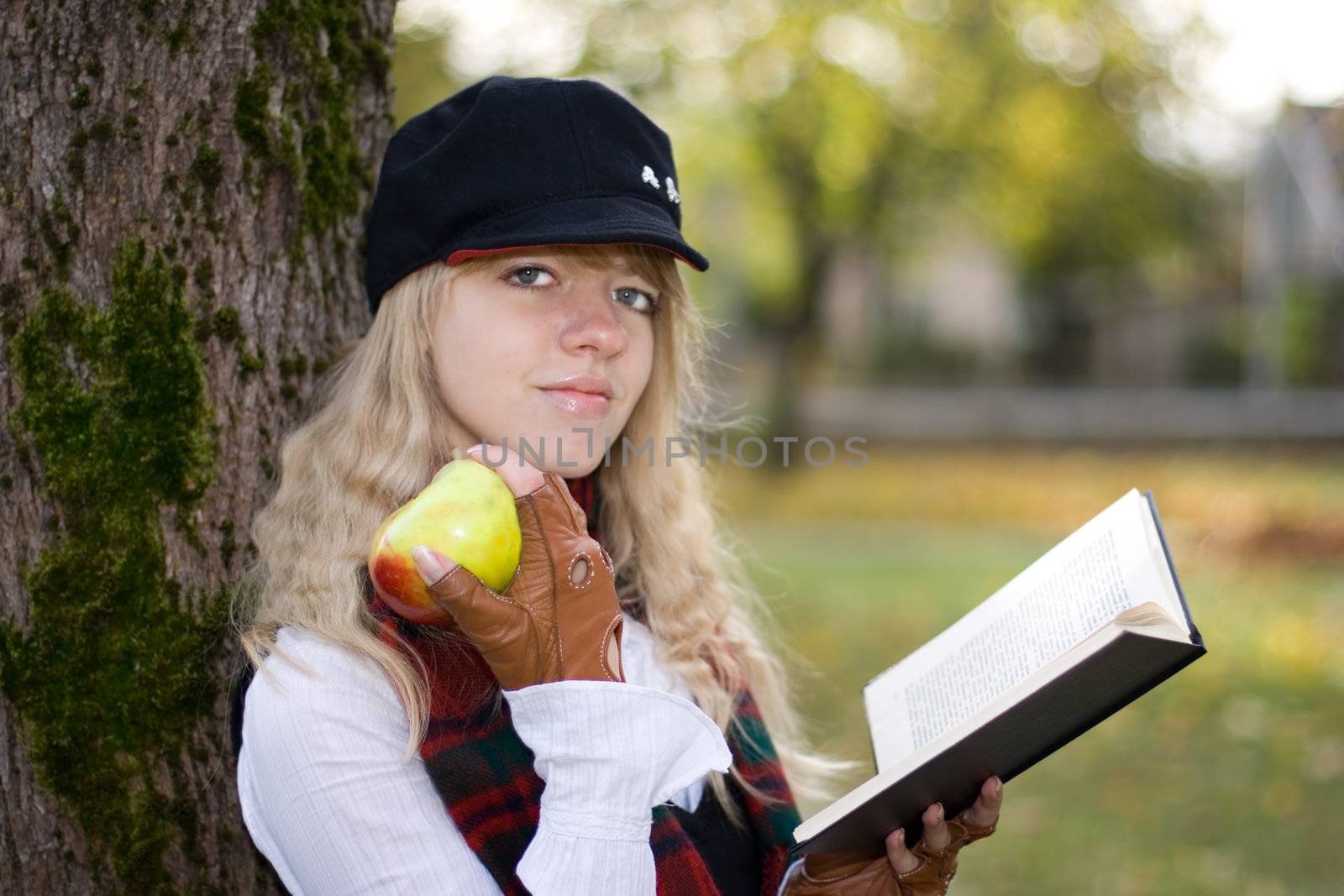 Student girl with a book in a hat by mihhailov