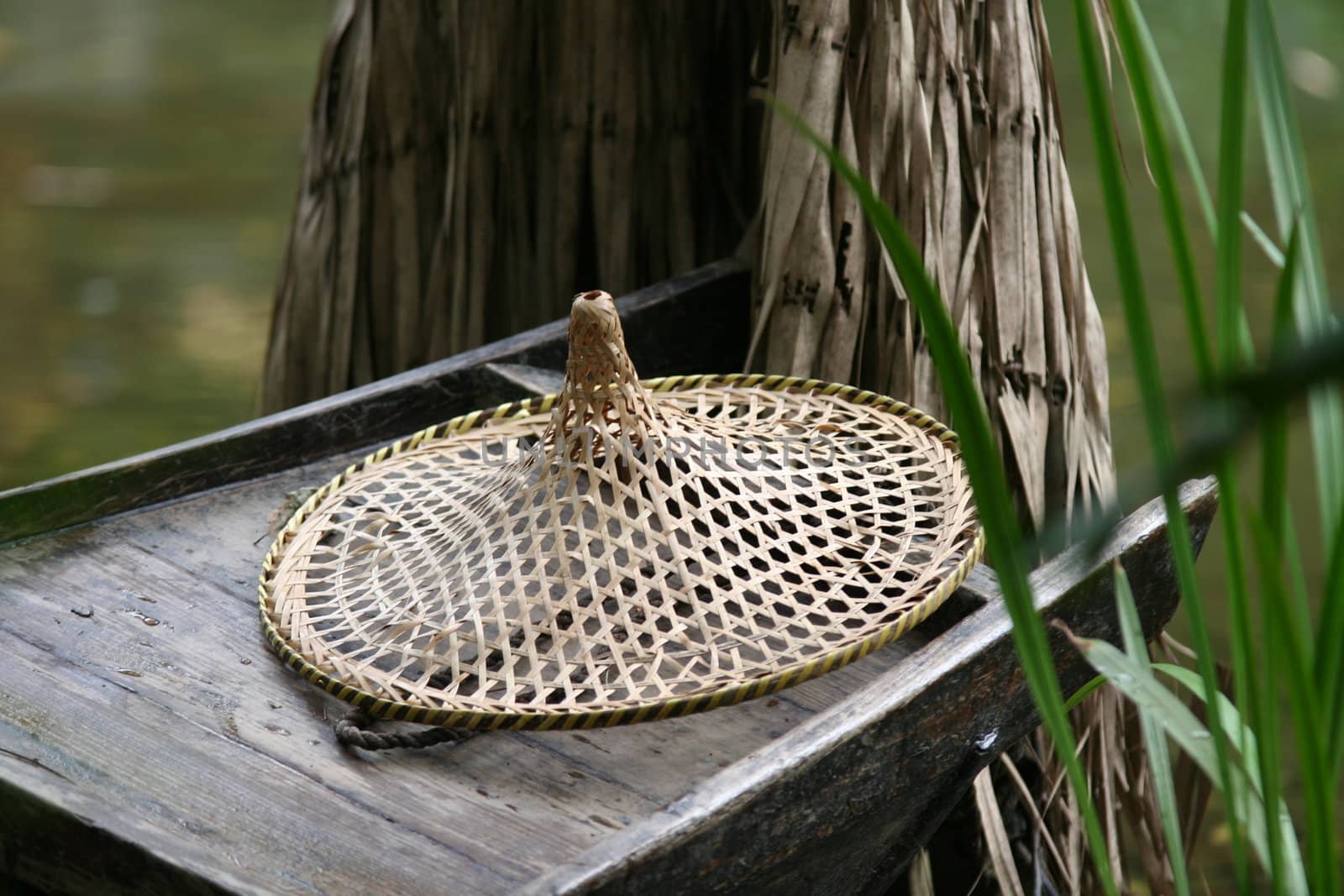 Traditional chinese hat on old wooden boat