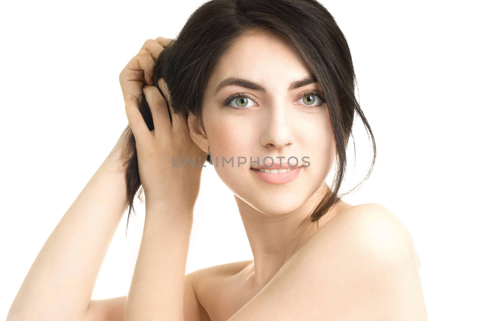 portrait of a beautiful young brunette woman touching her hair