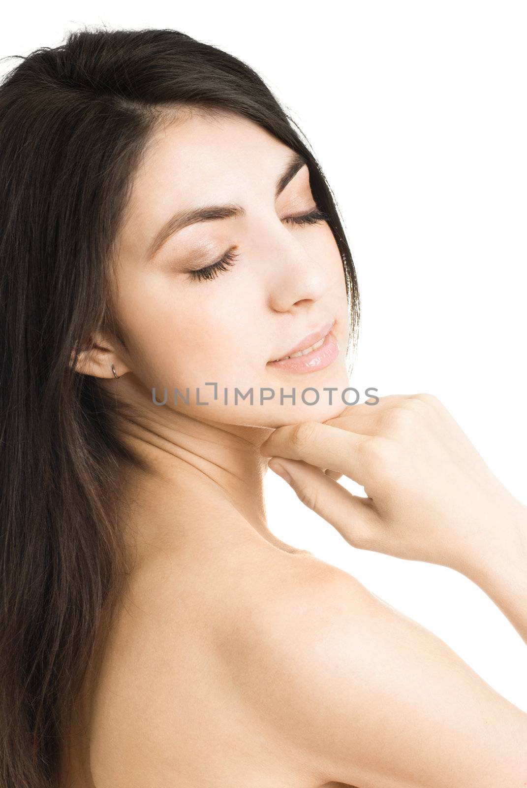 portrait of a beautiful young brunette woman touching her cheek