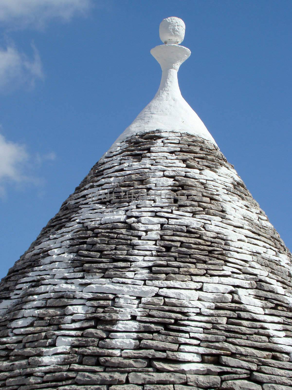 conical roof of trullo house in Apulia, region in Italy. Trulli are local,traditional Apulian stone dwelling with a conical roof. They may be found in the towns of Alberobello, Locorotondo, Fasano, Cisternino, Martina Franca and Ceglie Messapica.