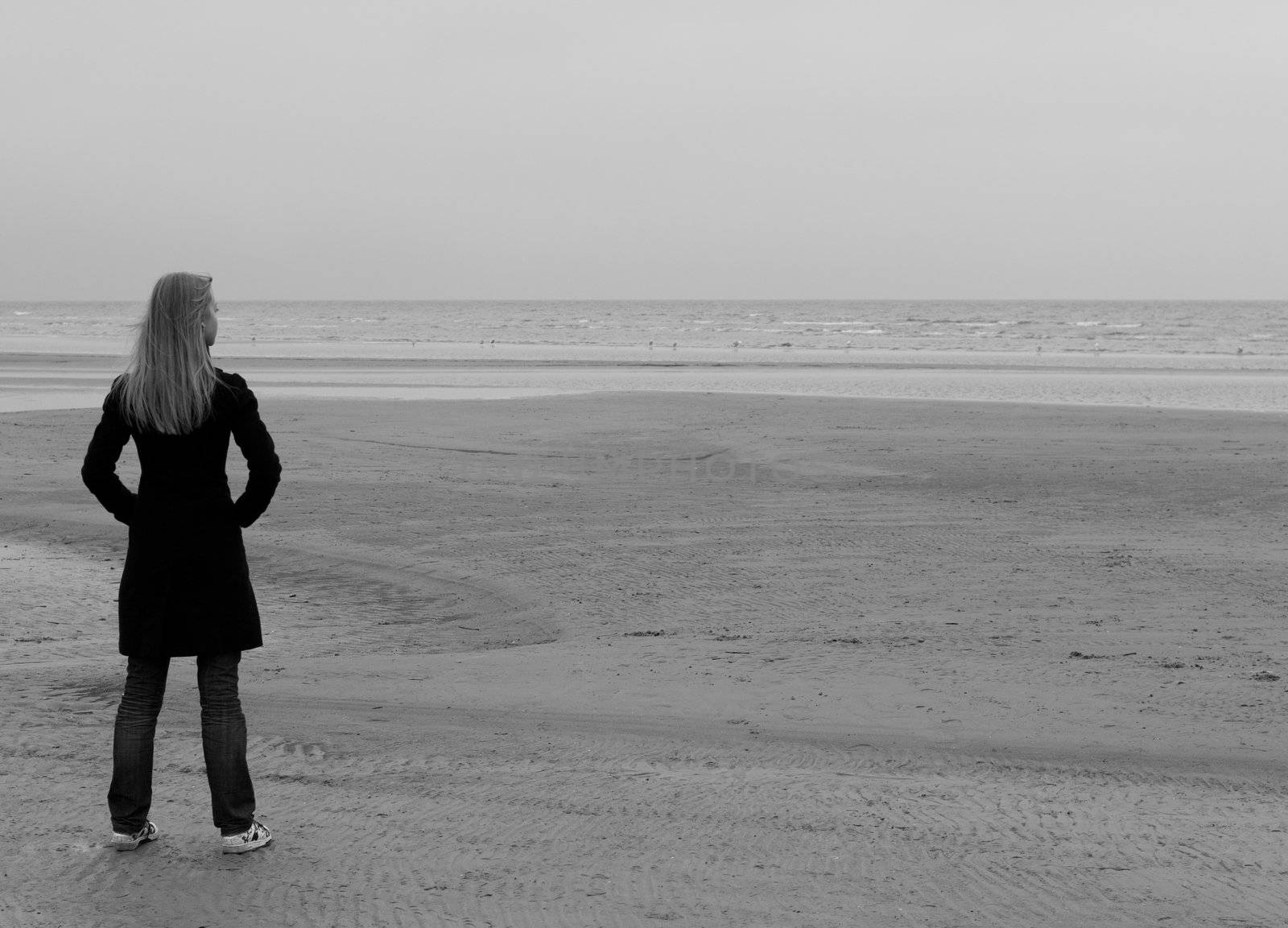 A lonely girl standing at the seashore
