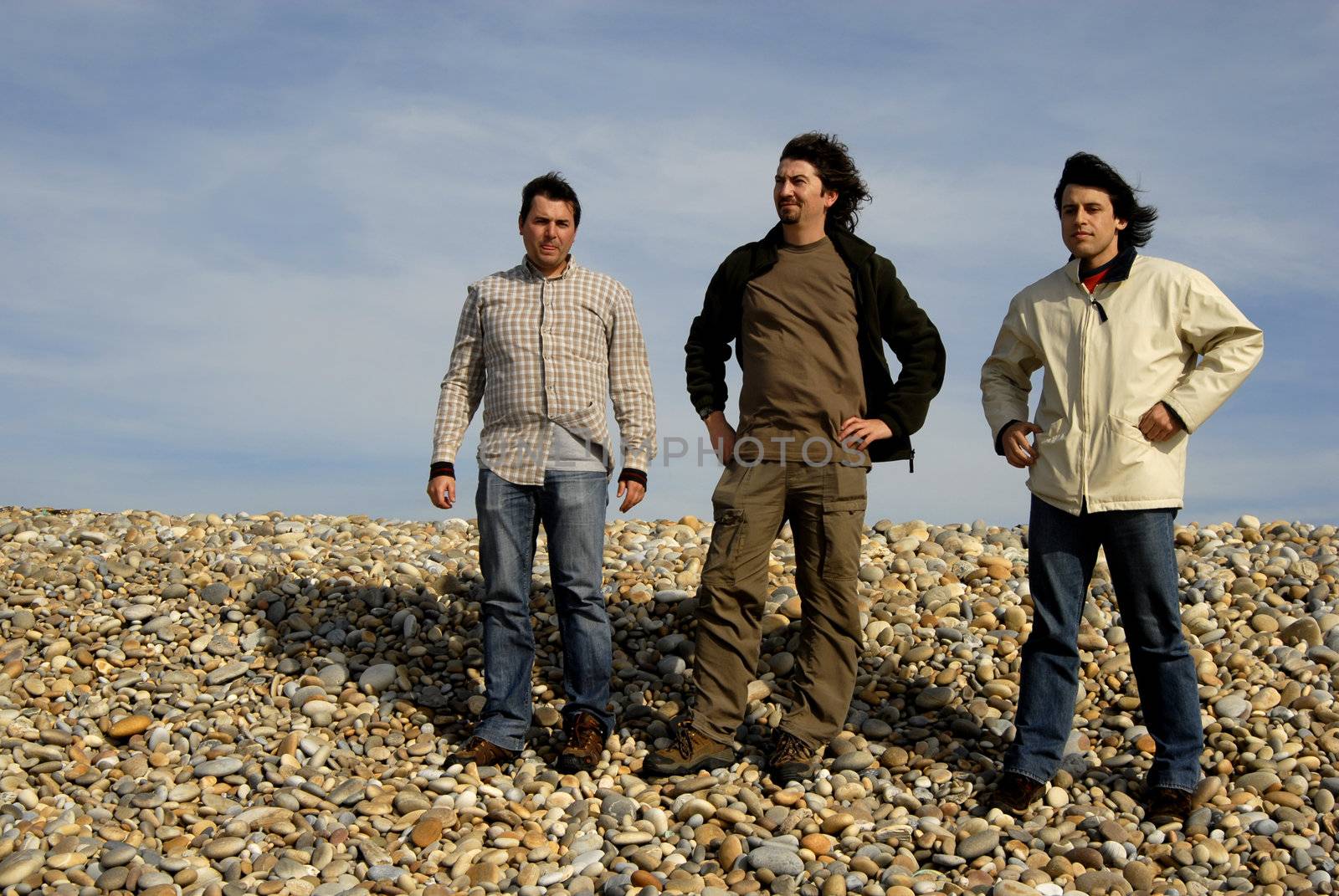 three casual young men at the beach