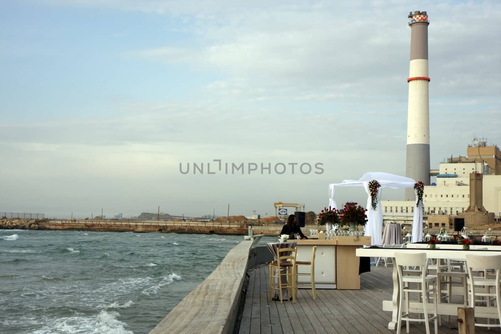 Chuppah with industrial view at the sea beach