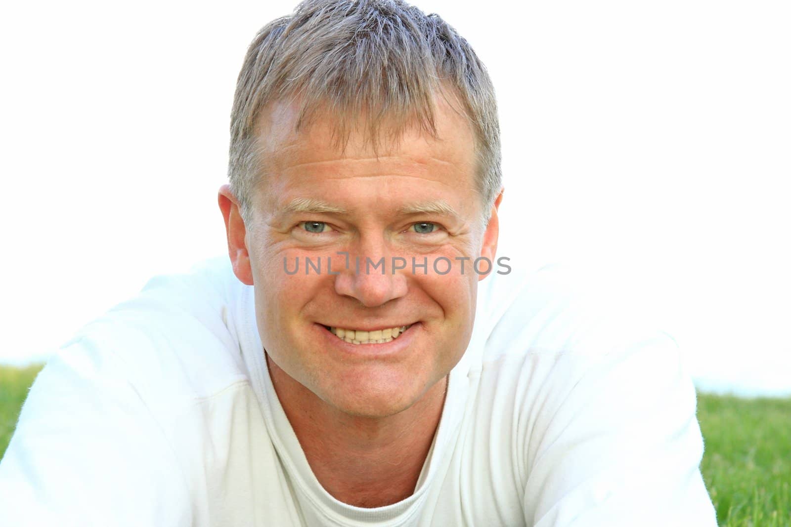 Happy young man poses in front of the camera