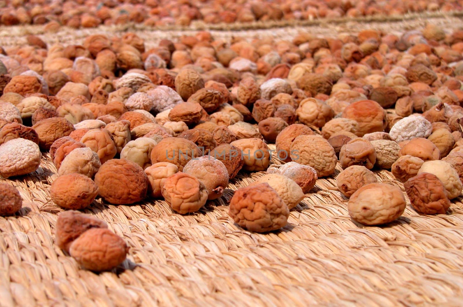 some fruits drying on a tatami in a very hot summer day.          