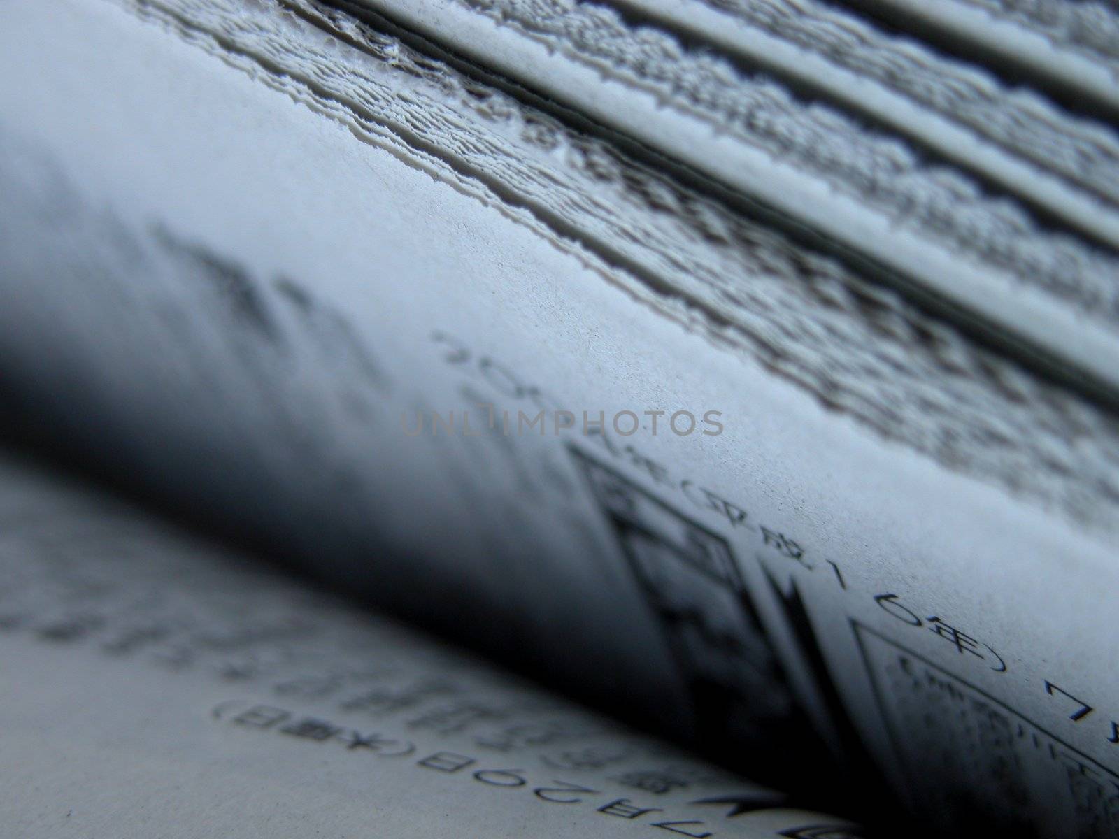 a stack of japanese newspapers.          