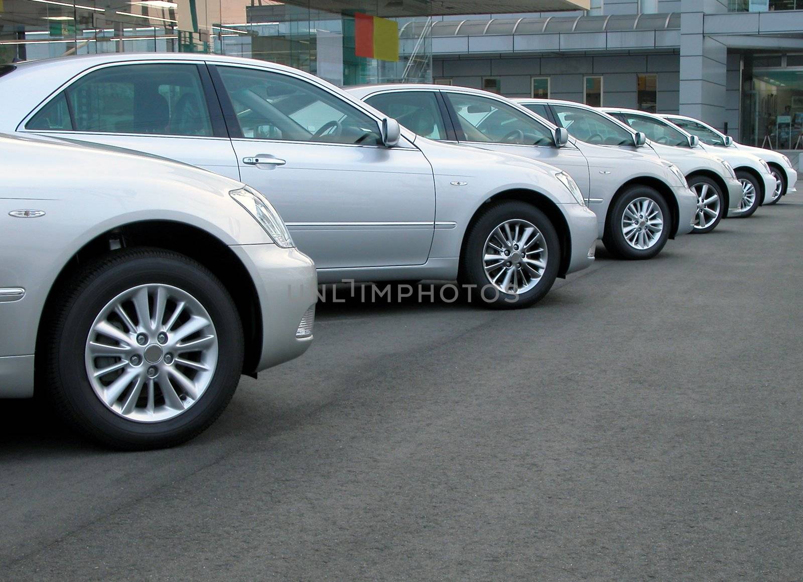 Cars row in front of a cars shop          