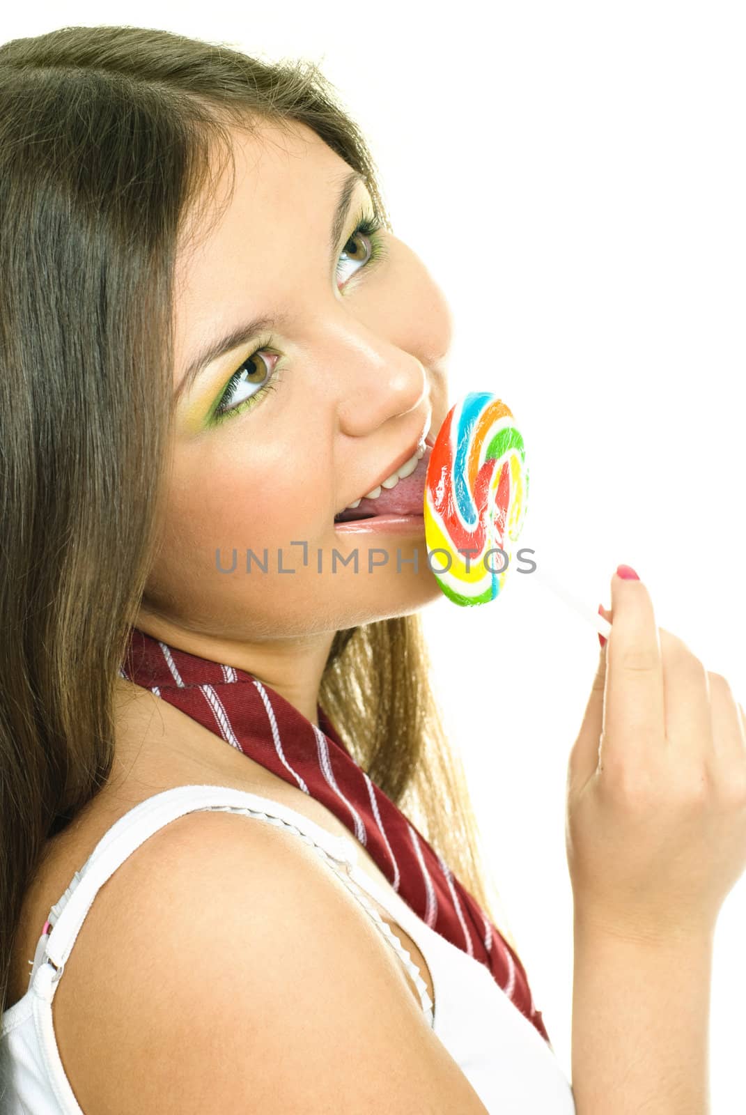portrait of a pretty brunette girl eating a candy and smiling