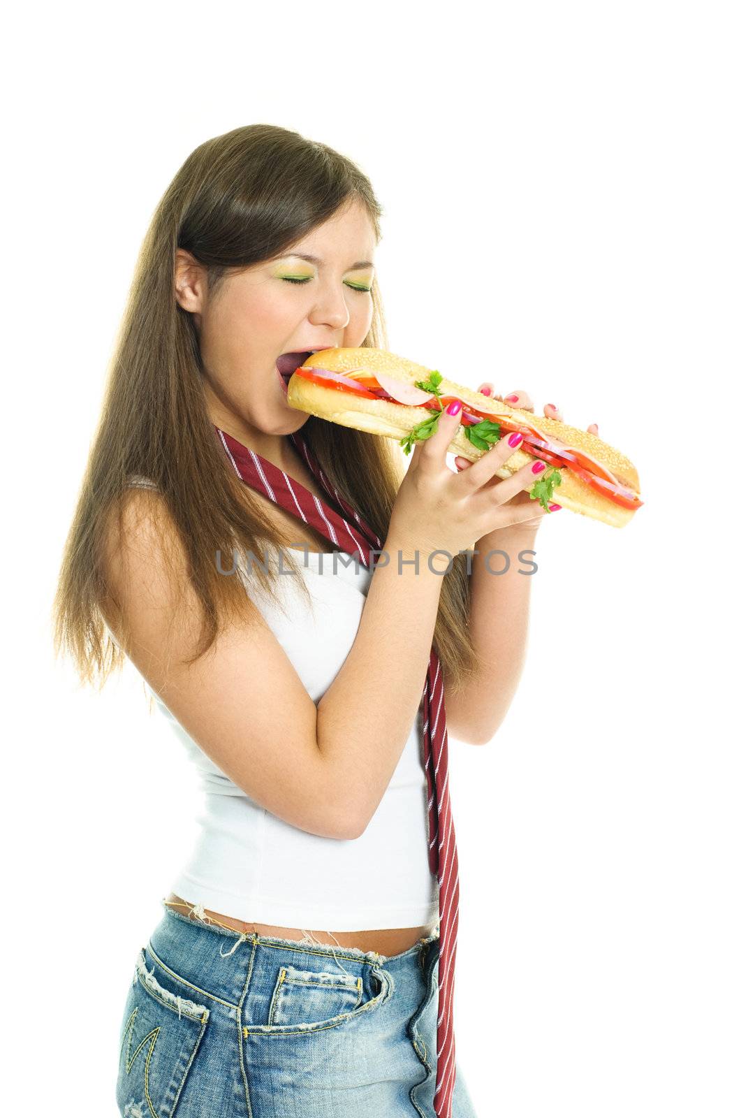 pretty young girl eating a huge hamburger, isolated against white background
