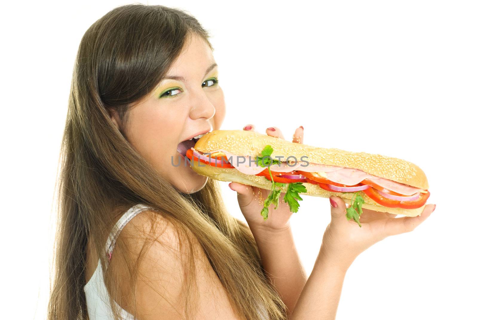 beautiful young woman eating a hot dog isolated against white background