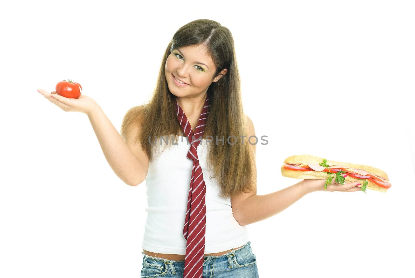pretty young brunette woman choosing between a sandwich and a tomato