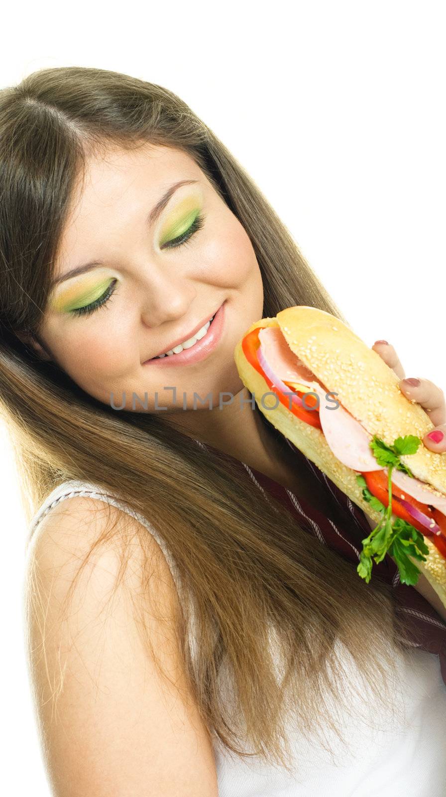 pretty young brunette woman eating a sandwich, isolated against white background