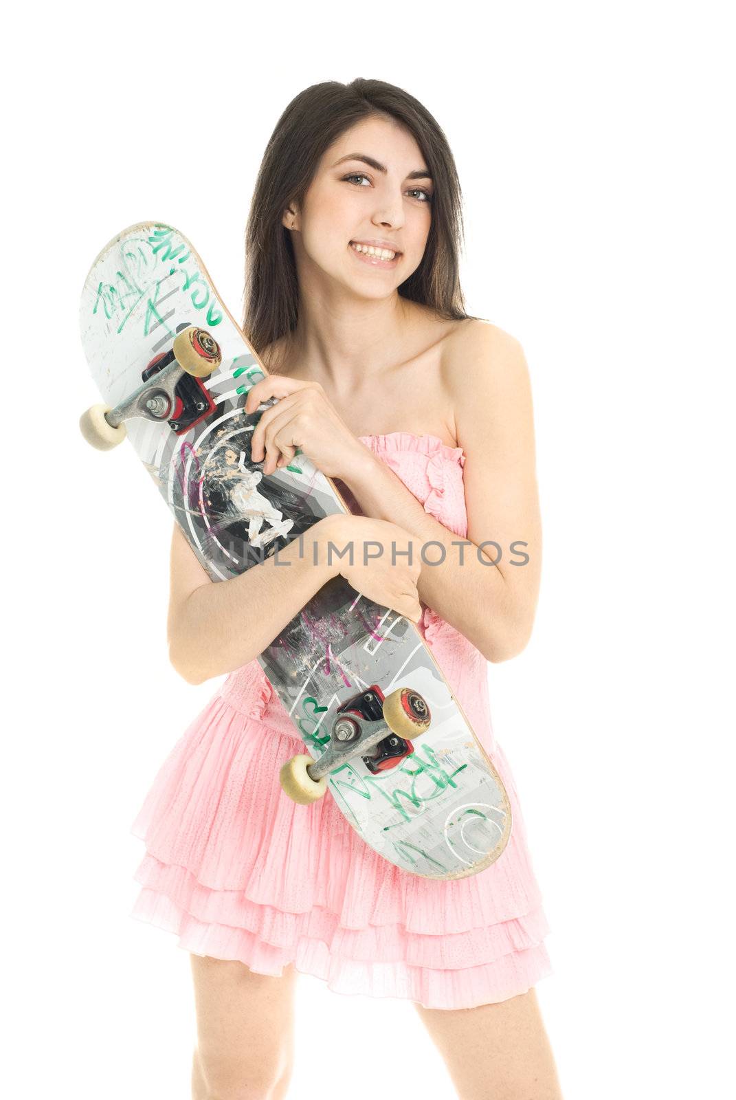 pretty brunette girl wearing a pink dress and holding a skateboard