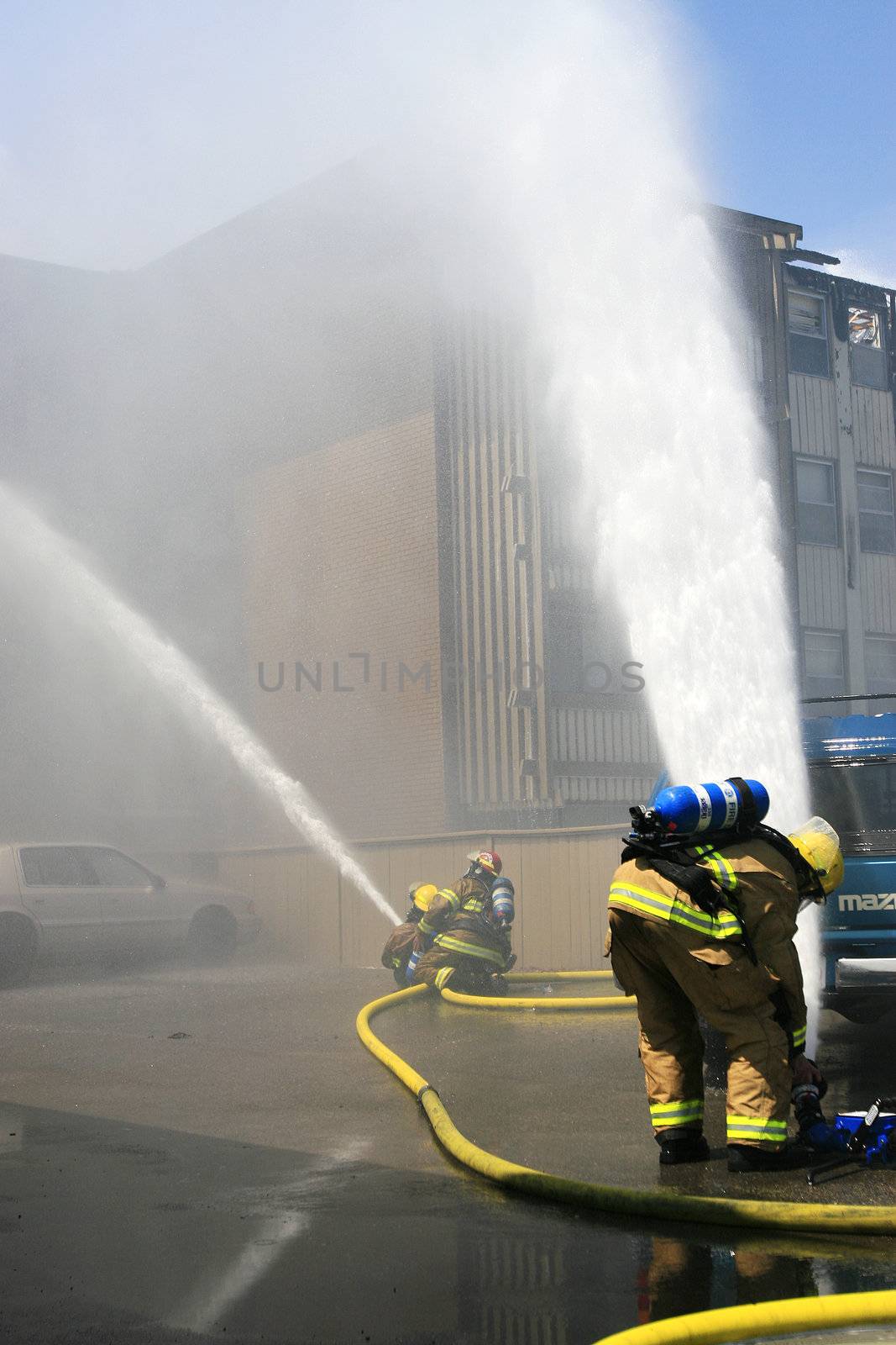 Firefighters battle a three alarm blaze.
