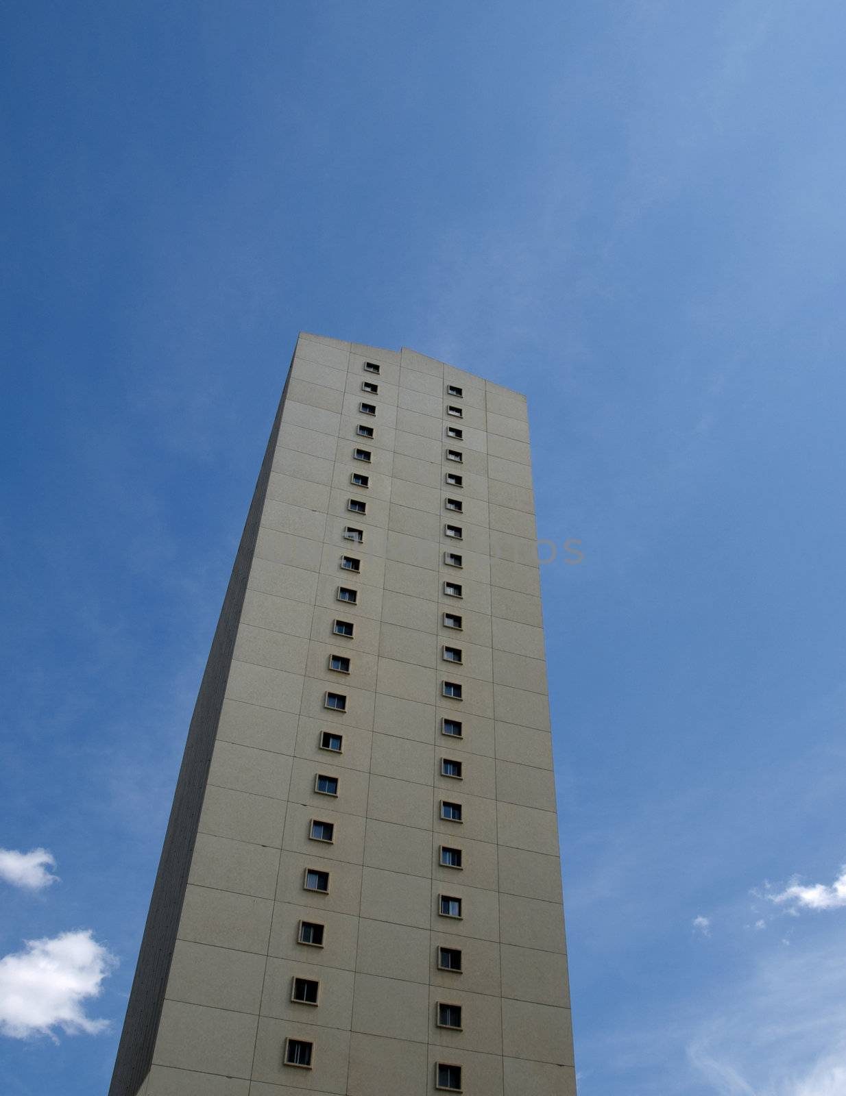 Isolated apartment building on the summer blue sky.