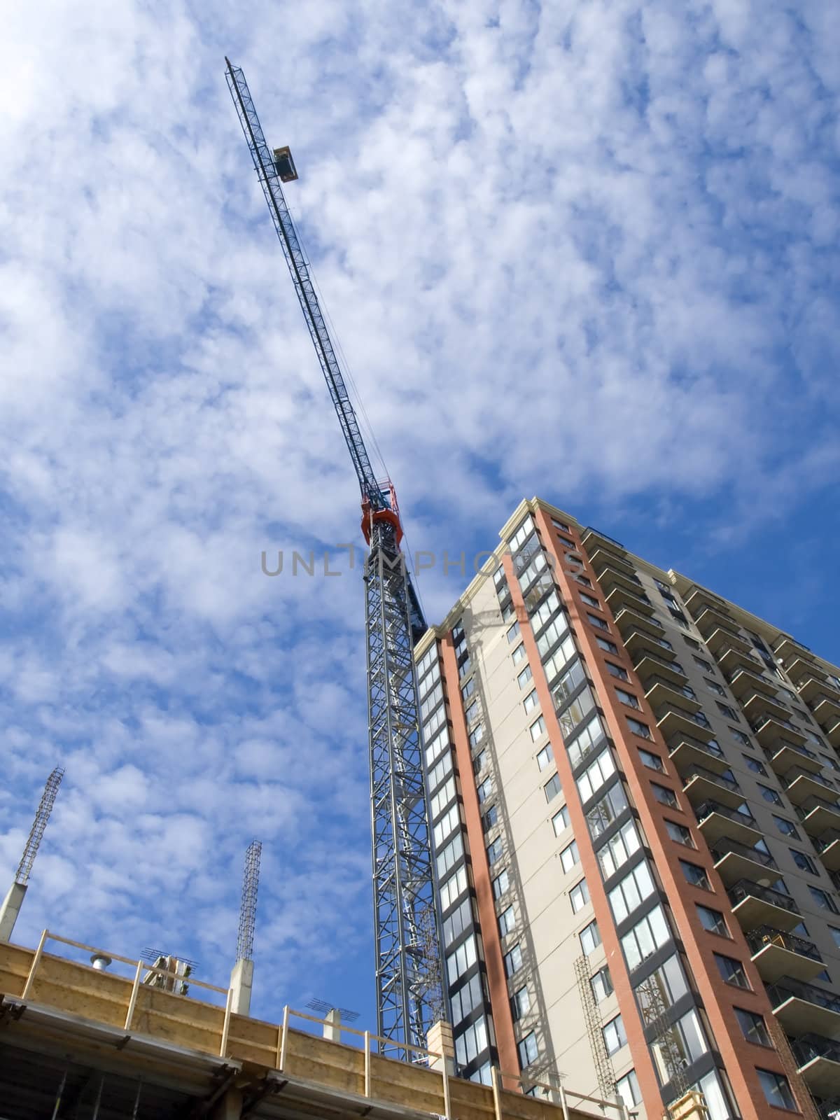 Crane towering over the city street on a condo construction site.