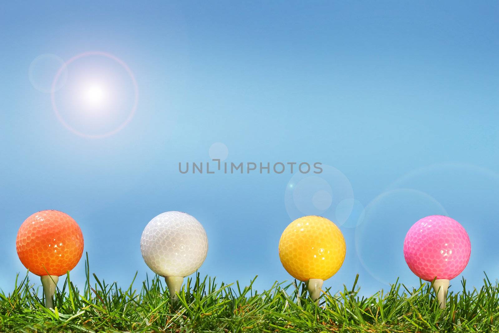 Colored golf balls in the grass by Sandralise