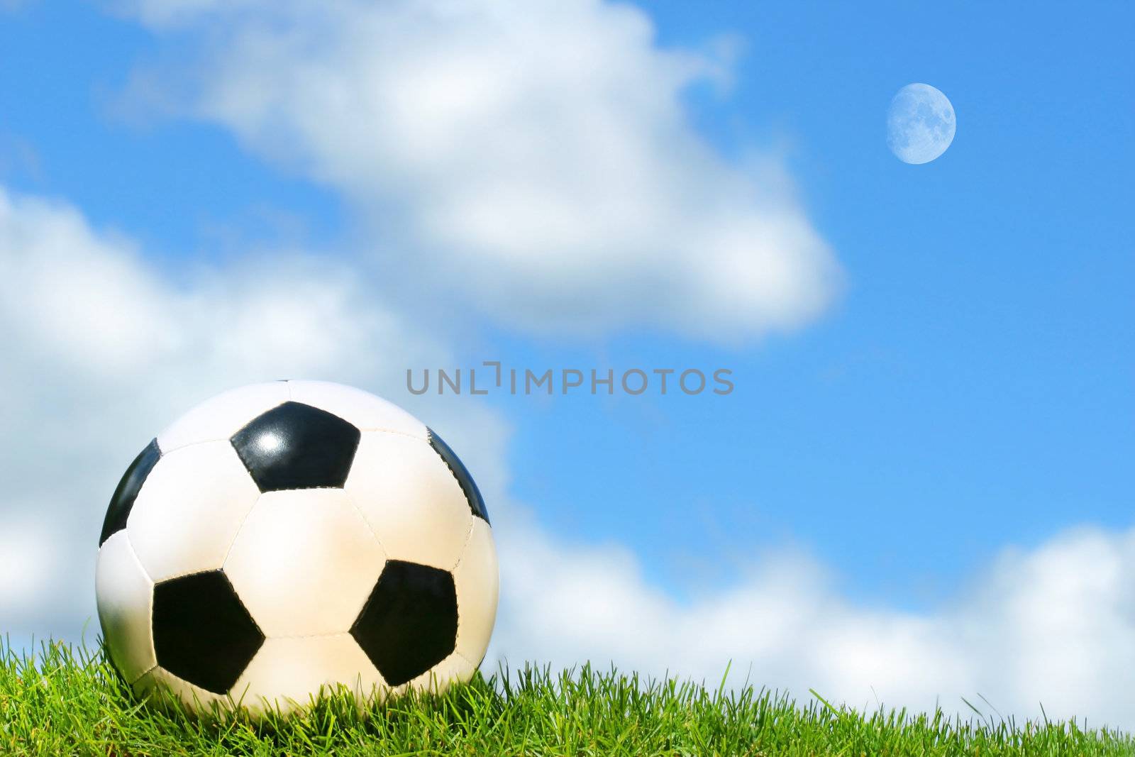 Soccerball against a blue sky by Sandralise