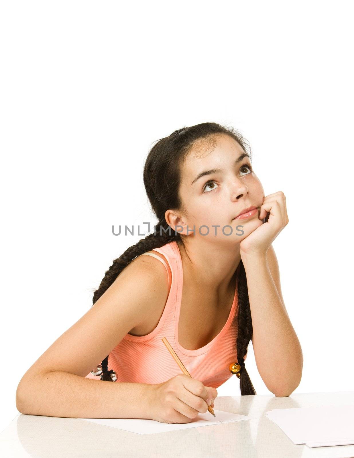 Teenager girl  with plaits  sitting at a table
