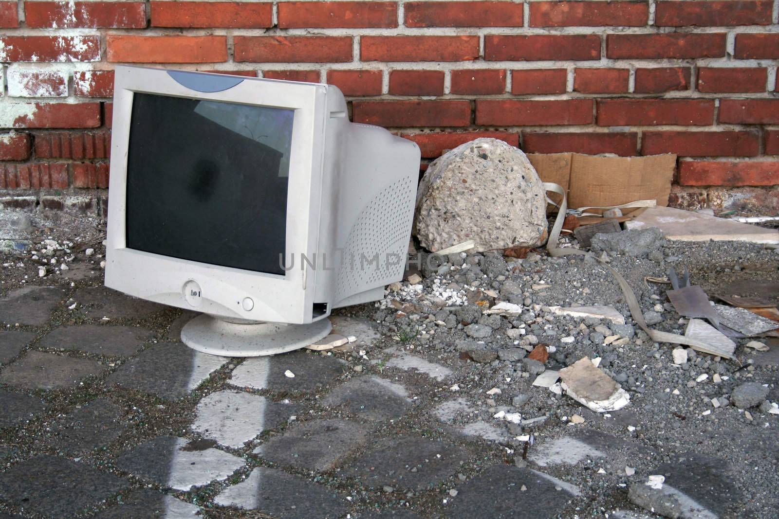 Broken CRT monitor dumped in an abandoned industrial backyard. March 2007.