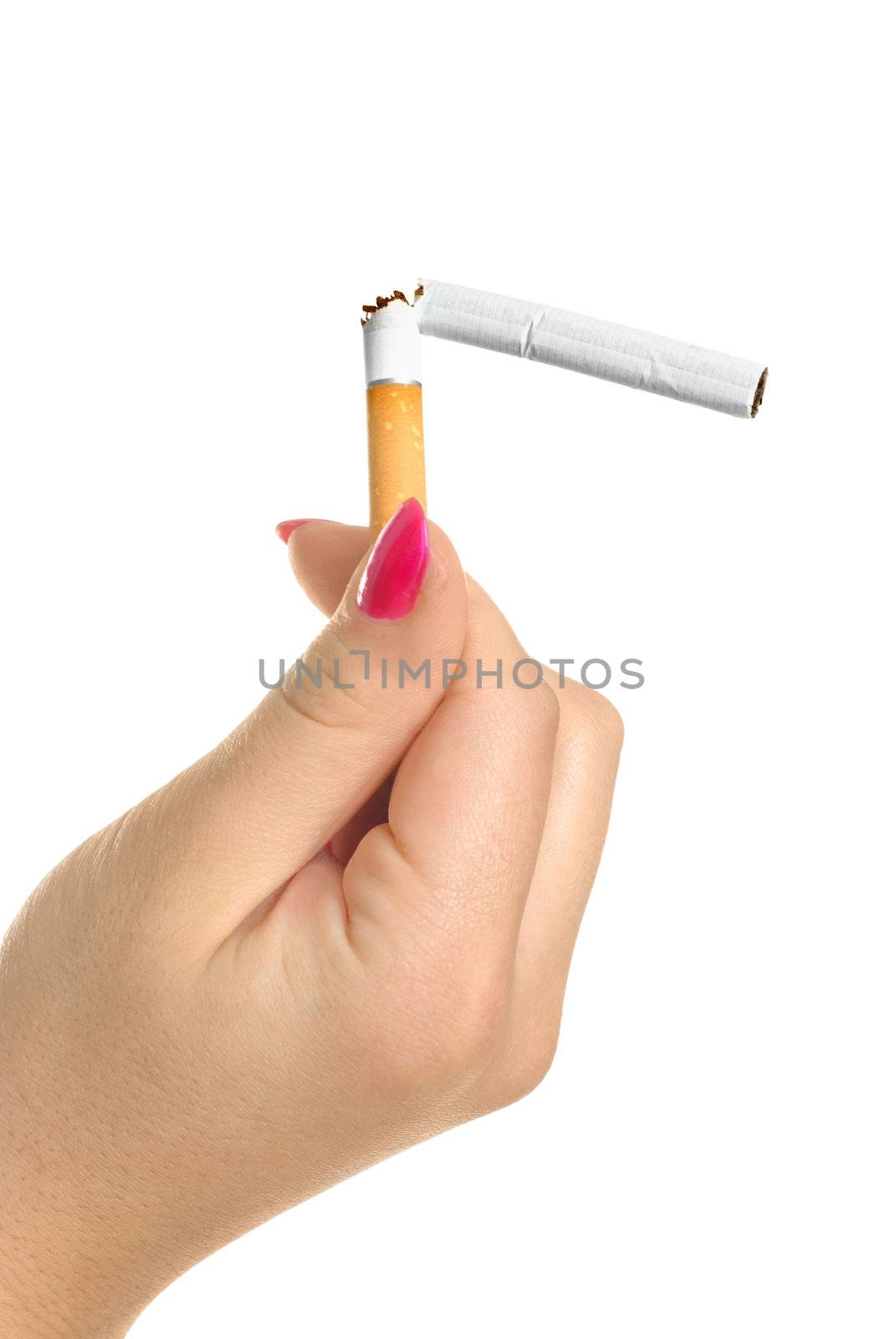 closeup of the hand of a young woman holding a broken cigarette 