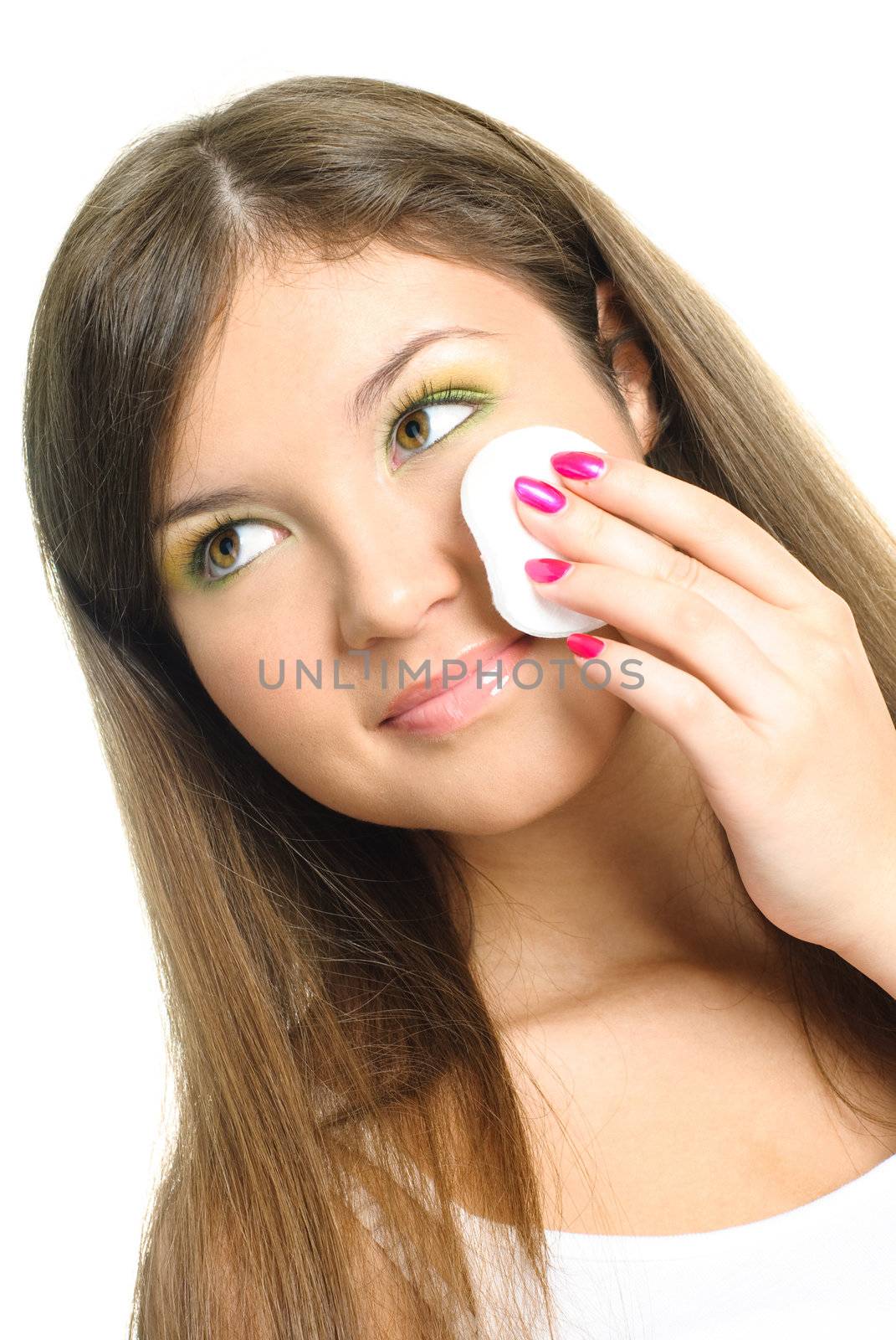 beautiful young woman removing makeup with a sponge