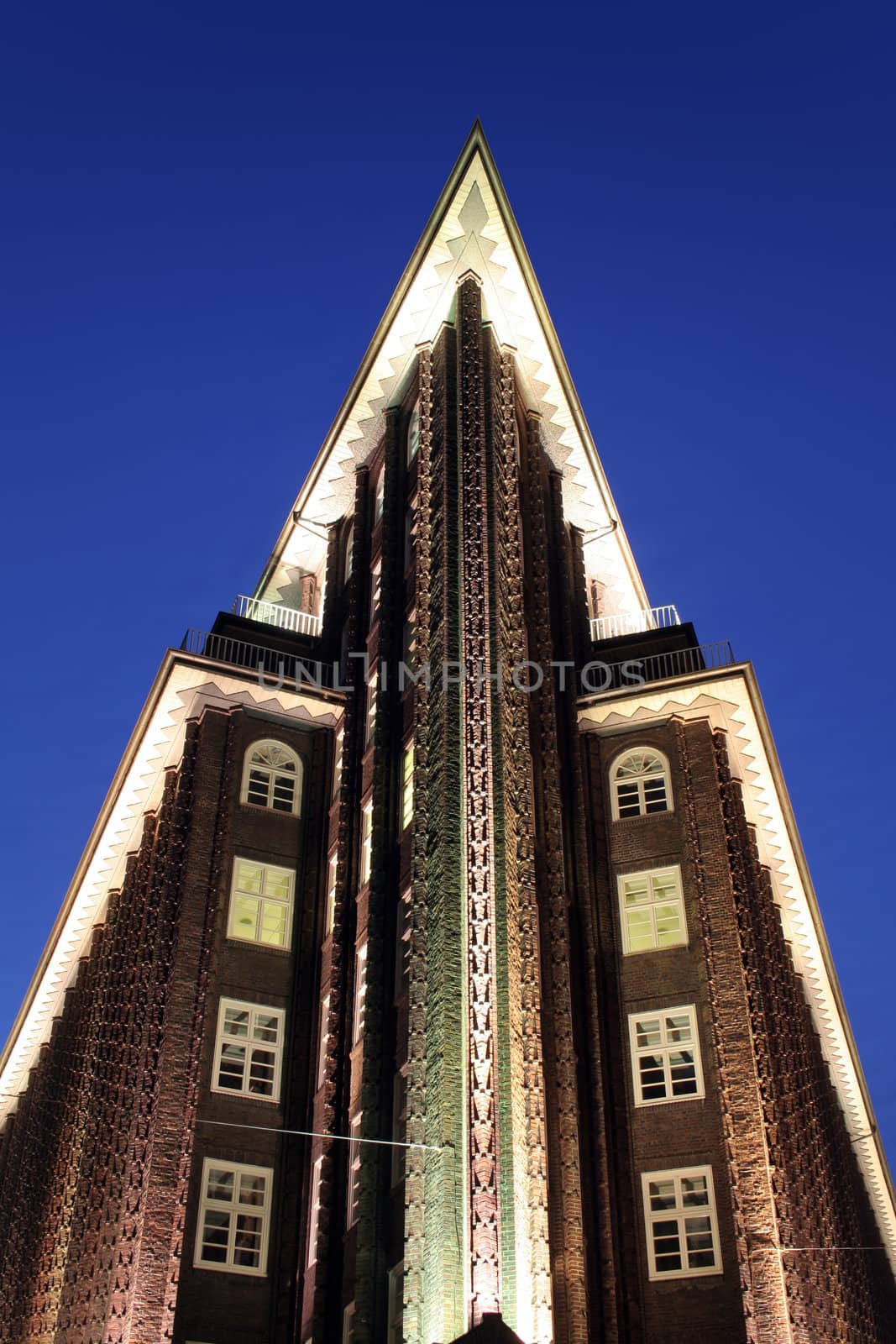 Illuminated office building at dusk during blue hour, Hamburg, Germany. Chilehaus, beautiful example of the Backsteinexpressionismus of the 1920s.
