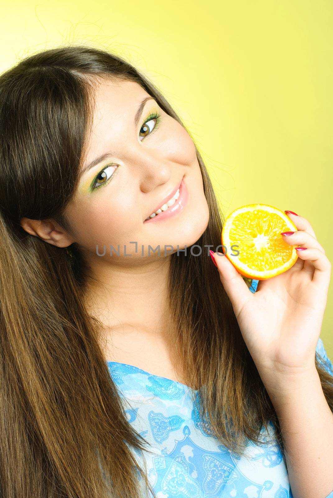 portrait of pretty young brunette woman with an orange