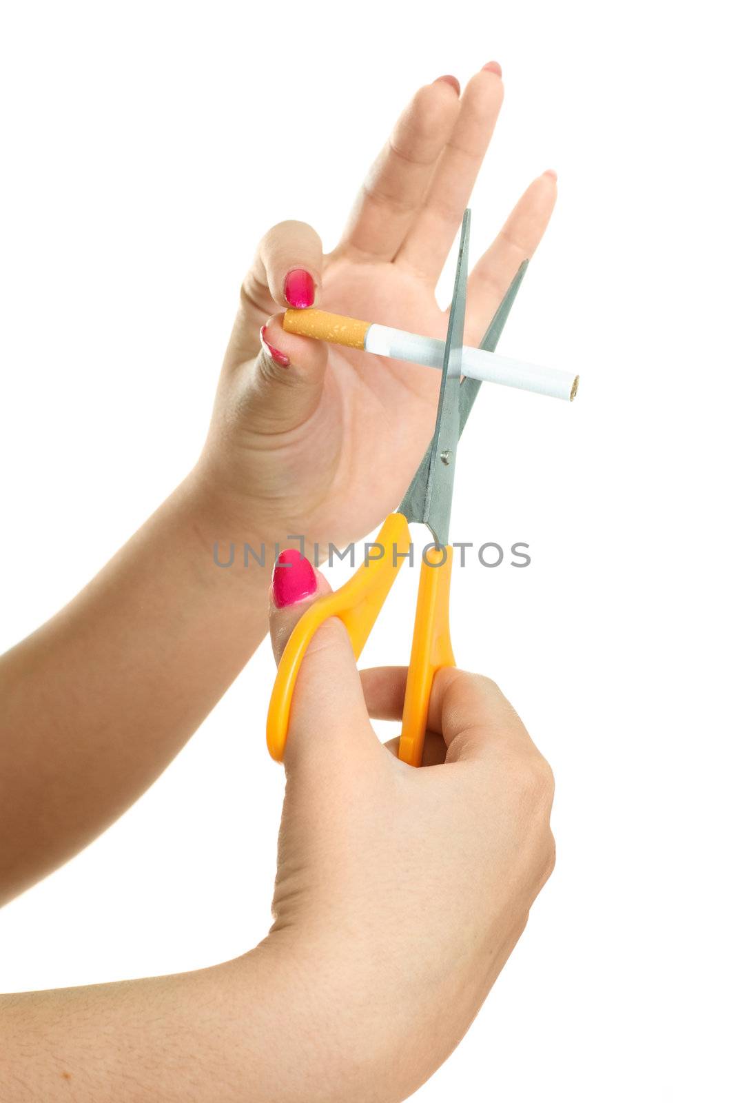 hands of a woman cutting a cigarette with scissors, isolated against white background