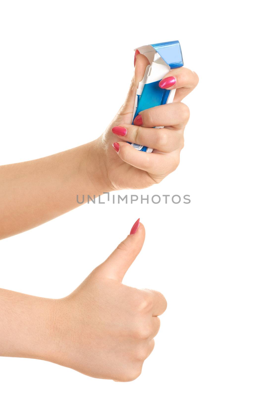 closeup of the hands of a young woman rumpling a pack of cigarettes and her thumb up