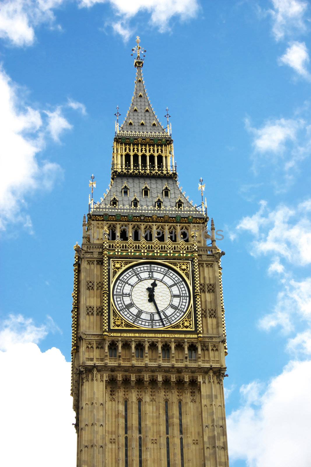 Big Ben with fluffy white clouds and blue sky