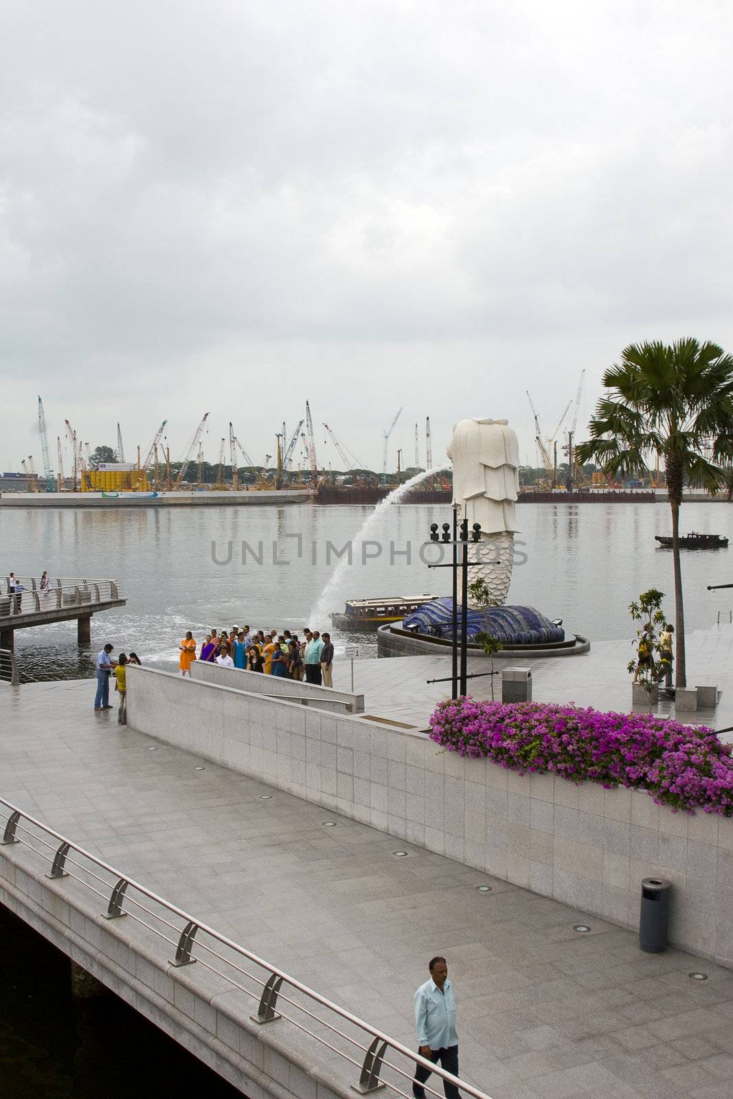 The monument of Singapore - the fabled Merlion. Told to be observed by one of the founders of Singapore, it has since become a national landmark, much as the Angkor Wat in Cambodia.

In this photo, you can see the tourists taking their photograph in front of it, as well as the construction of new buildings in the background. All of Singapore - old and new - in one!