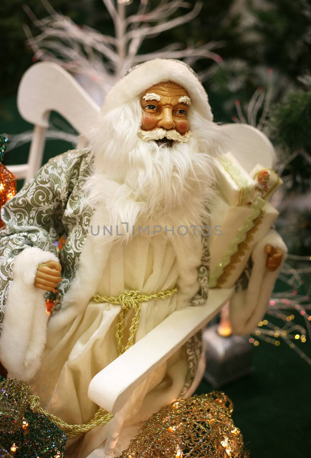 Toy Santa Claus with gifts on white sledge