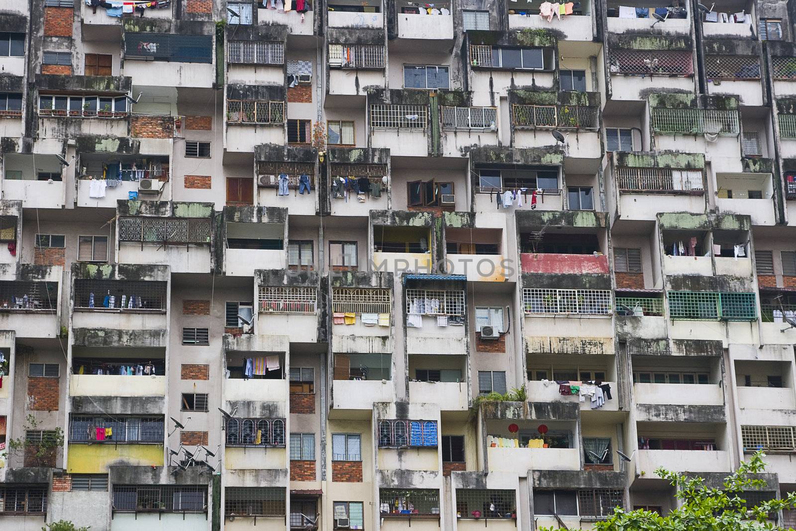 A close up of a large residential building in Kuala Lumpur, Malaysia. Typical for Asian cities, people live cramped together over little space. This is a good illustration of how chaotic it might seem. 