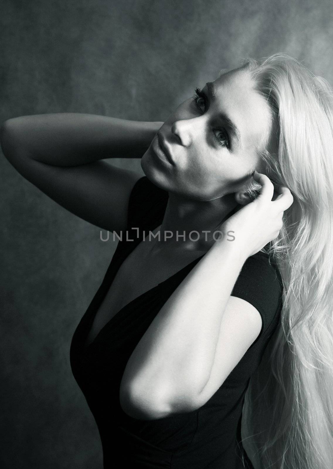 Portrait of the beautiful blonde in studio. b/w+blue tone