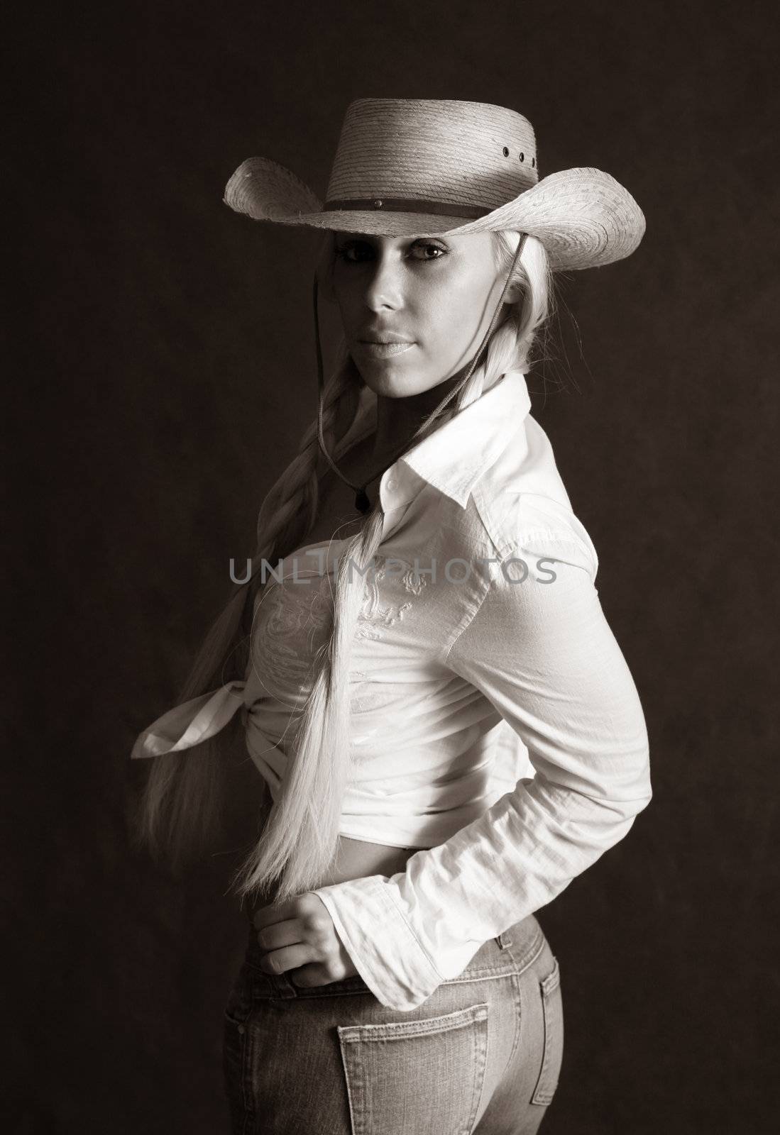Portrait of the beautiful blonde in hat. b/w+sepia