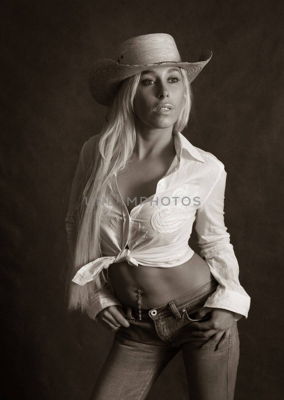 Portrait of the beautiful blonde in hat. b/w+sepia