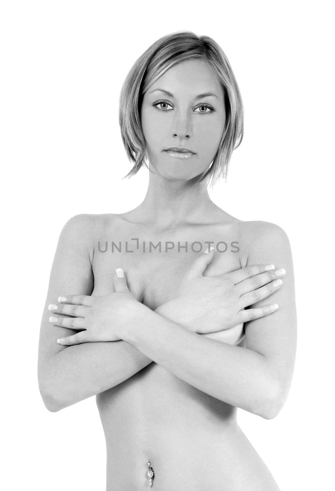 Nude blond woman covering her breasts with her hands
