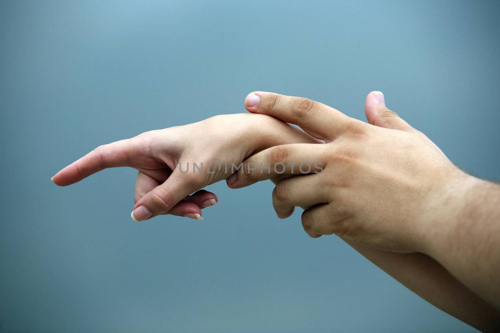 Man's and female hand on a background of the sky