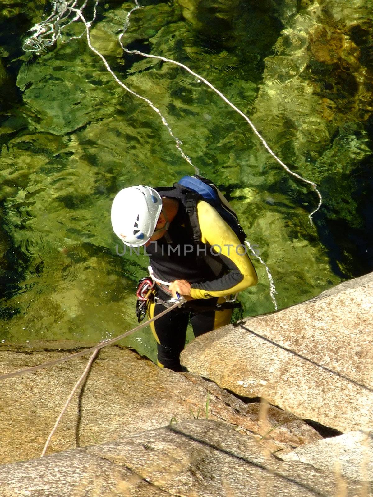 Men preparing to descend waterfall