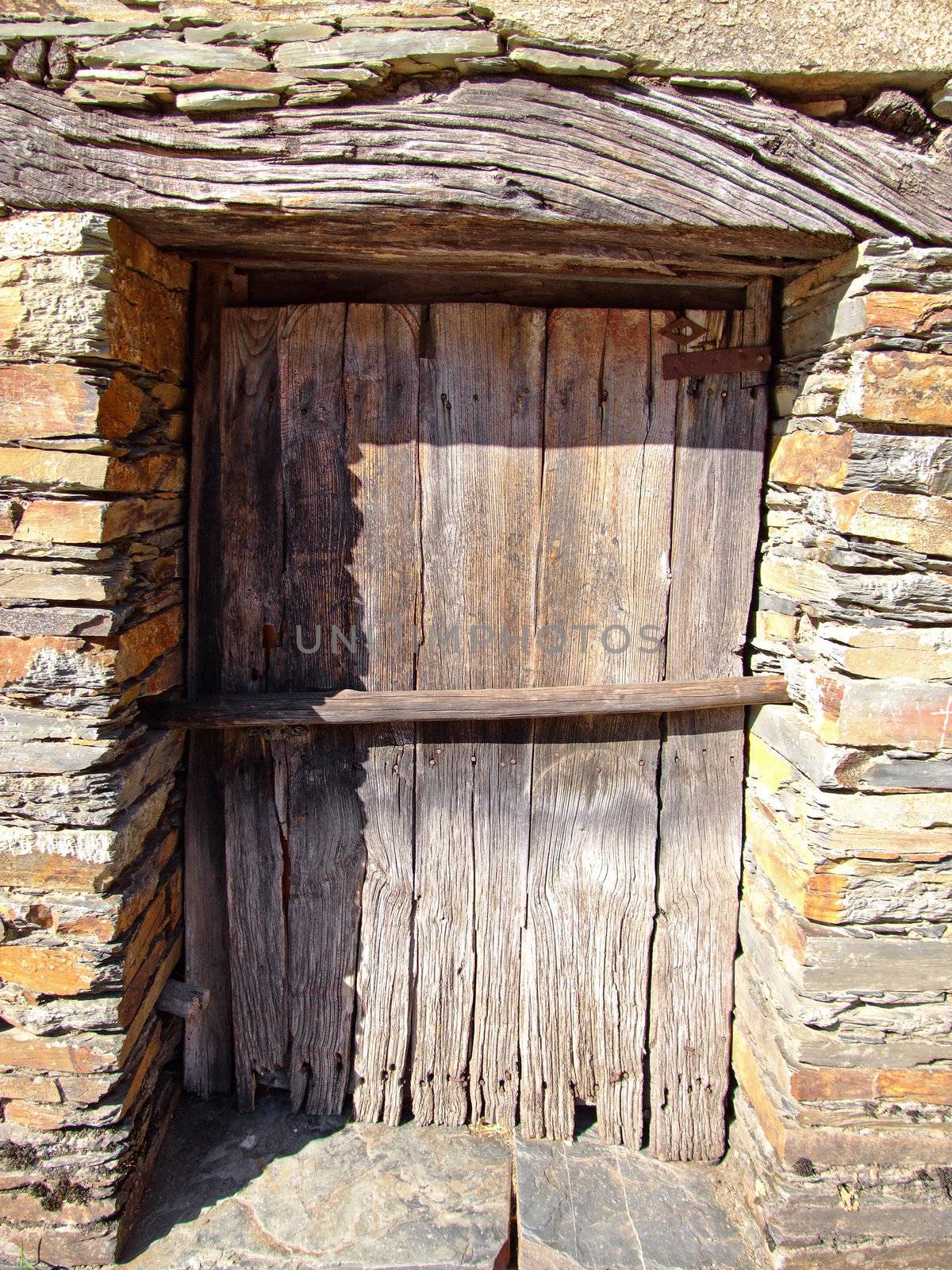 Rustic wood door on stone house
