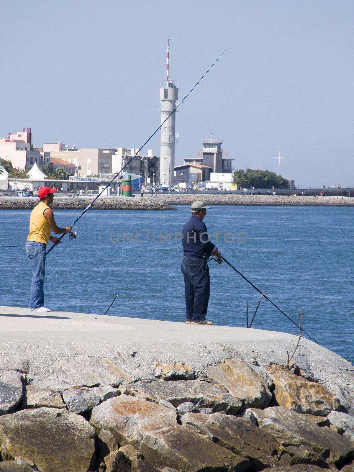 Two mens fishing on sea coast 