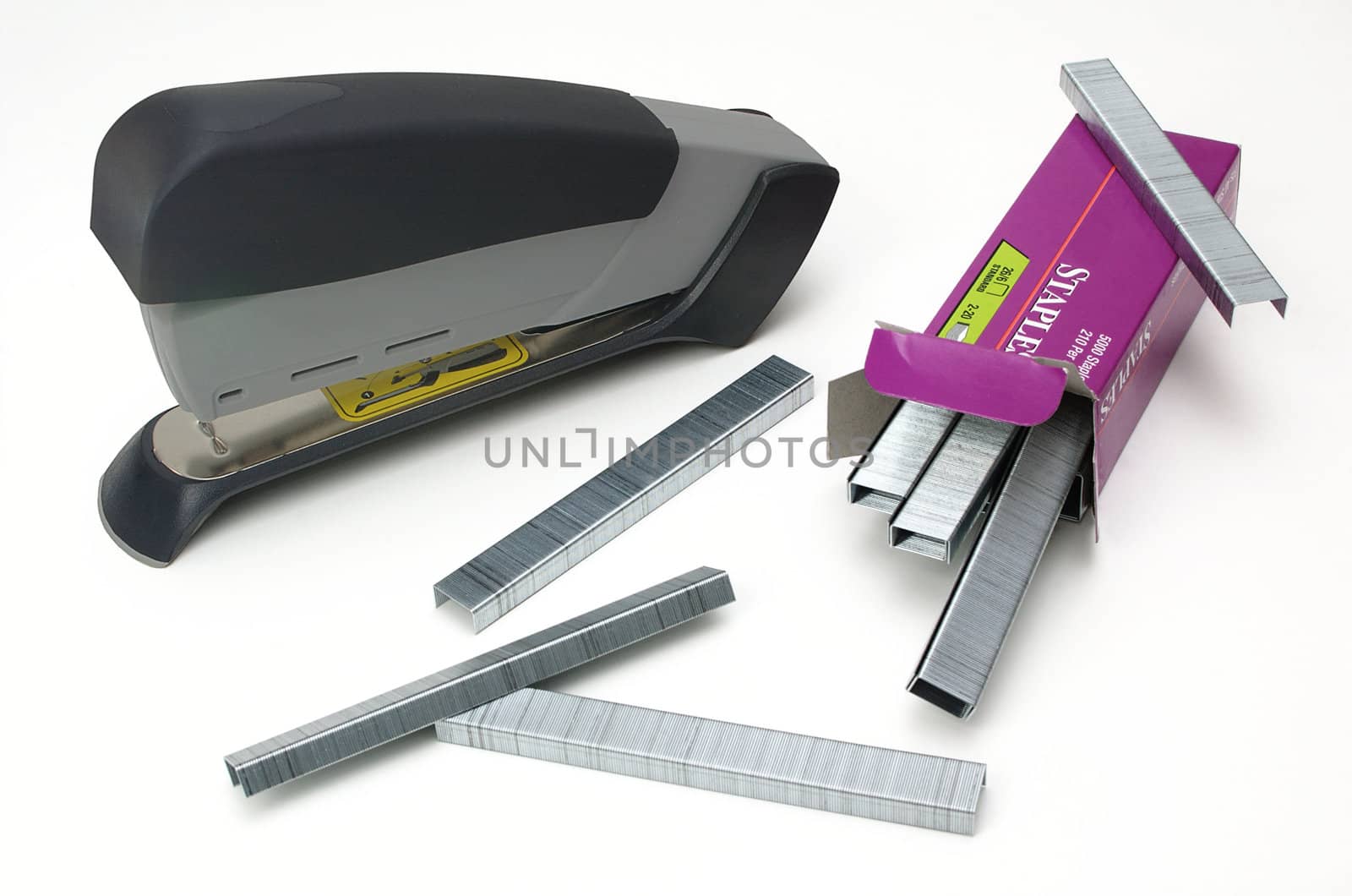 A stapler and some staples, including the box, isolated against a white background.