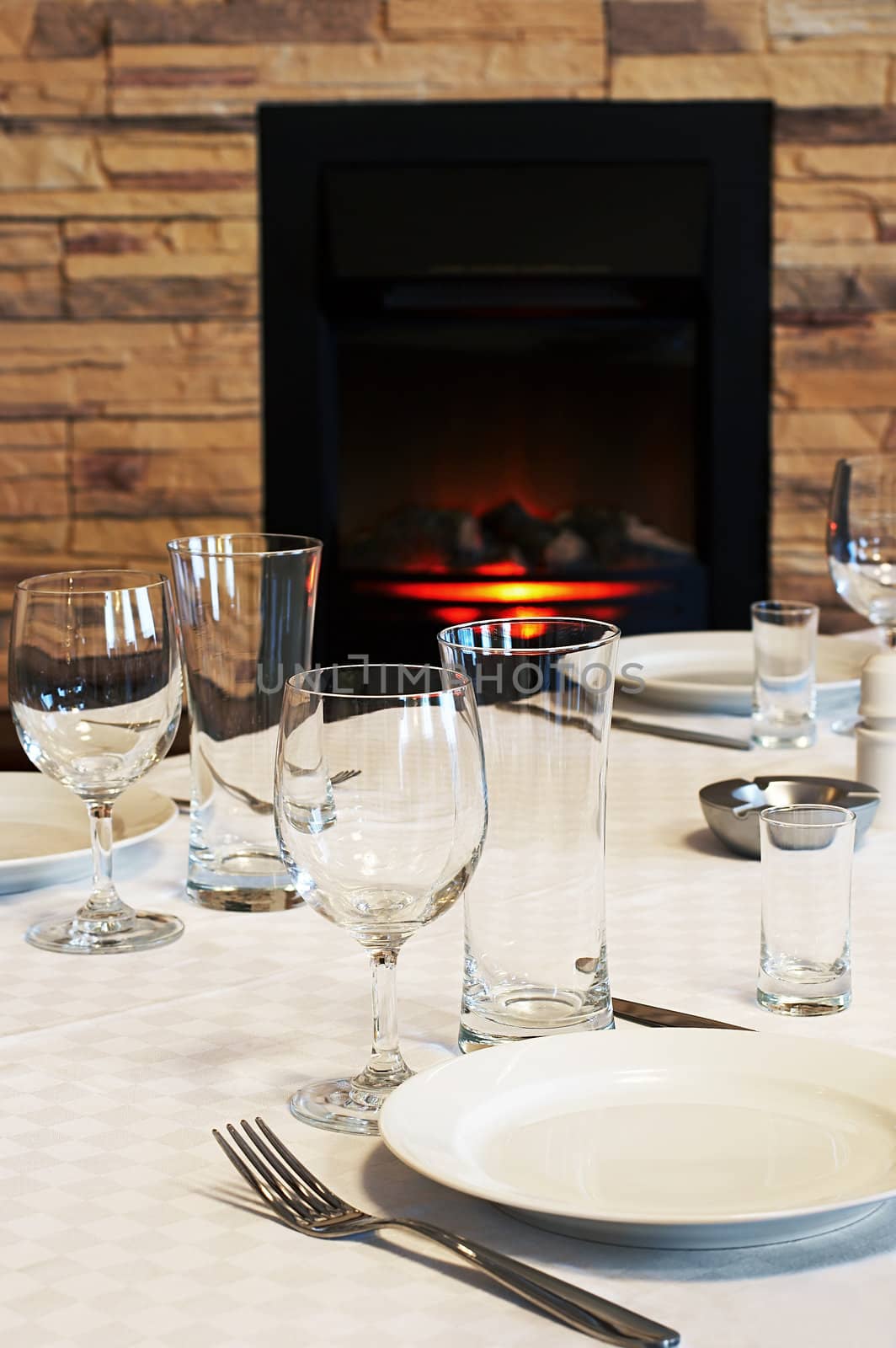 Dining table at a fireplace in modern hotel