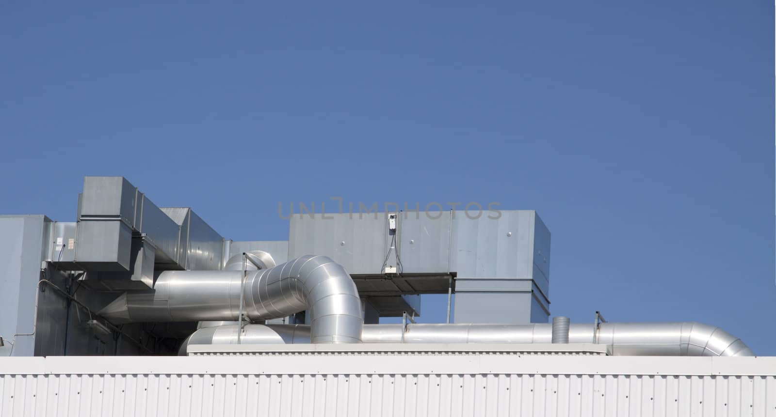 An industrial cooling unit on top of a building