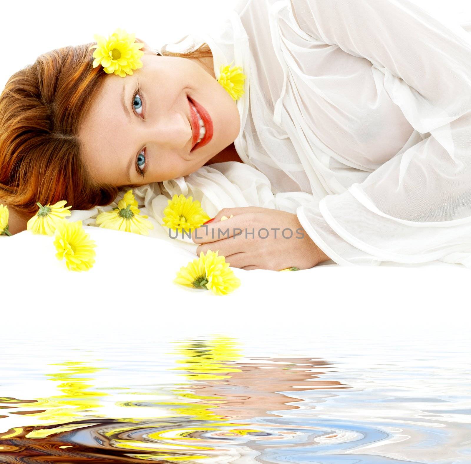 portrait of lovely beauty with yellow flowers on white sand