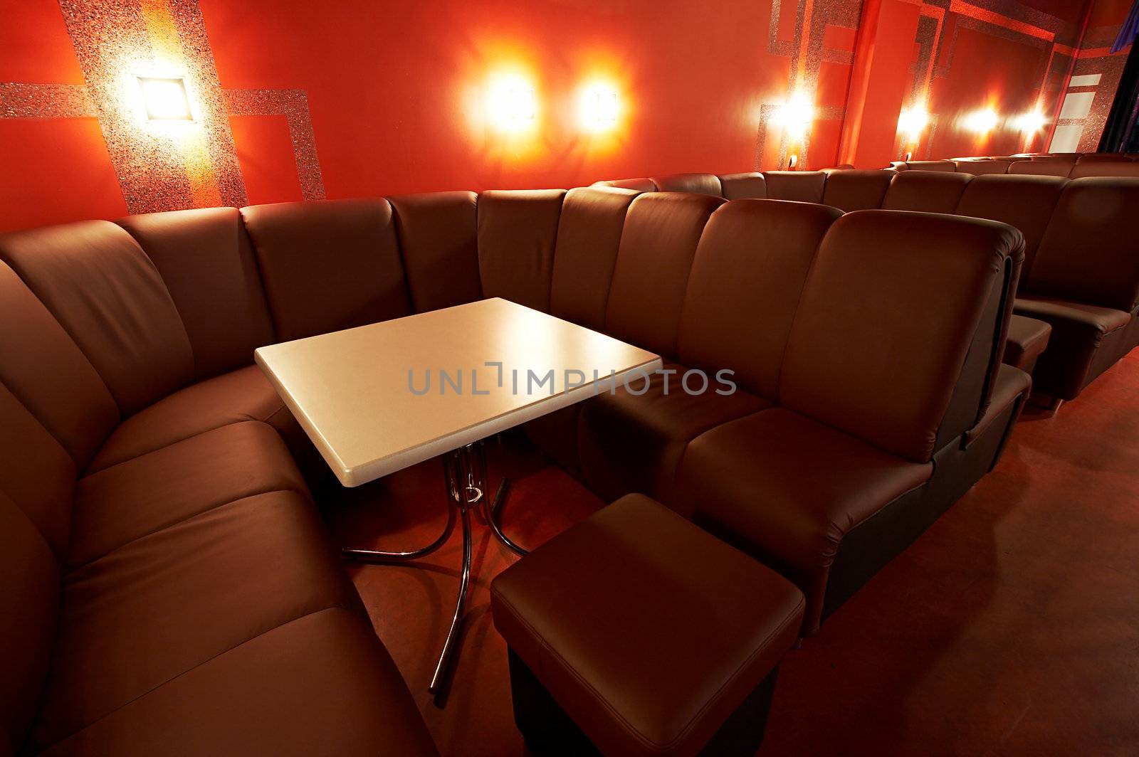 Table and soft sofas in a modern night club