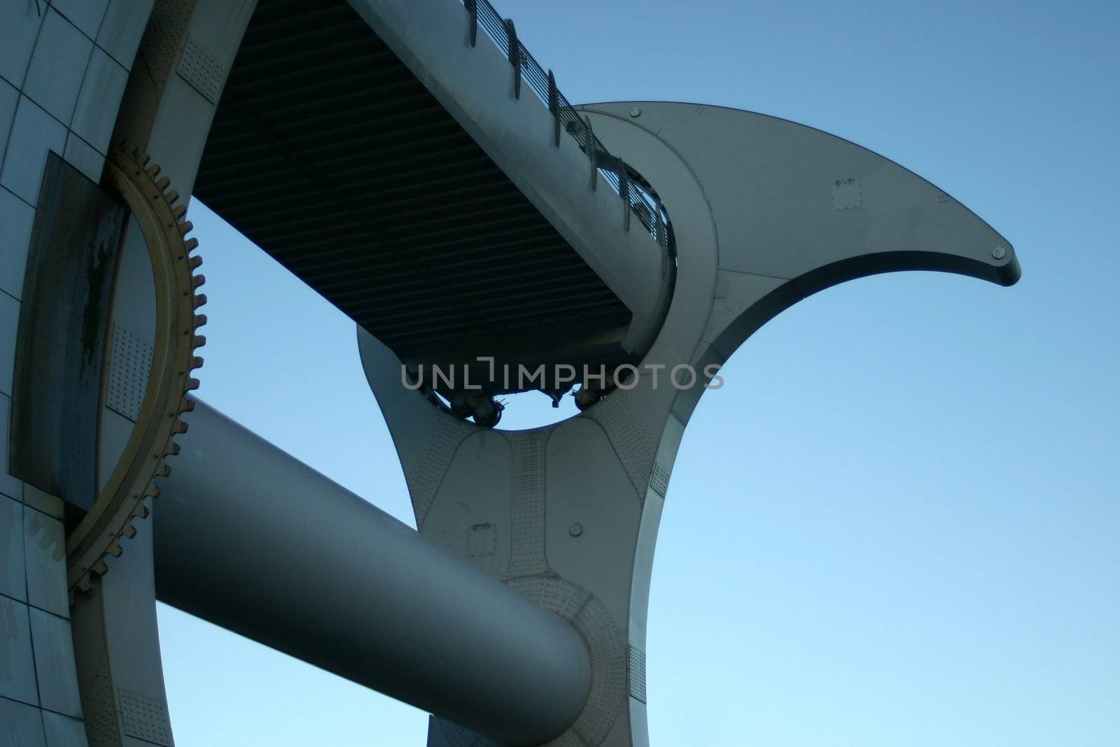 Detail of Falkirk Wheel (rotating boat lift for canal boats between the Forth and Clyde Canal and the Union Canal, Scotland, UK, against blue sky.