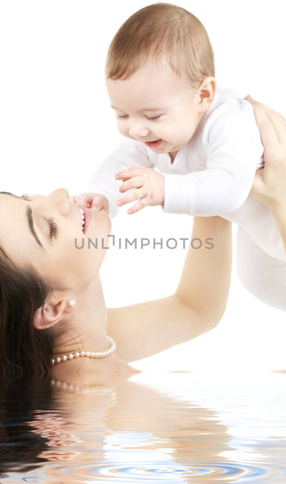 happy mother with baby boy in water by dolgachov